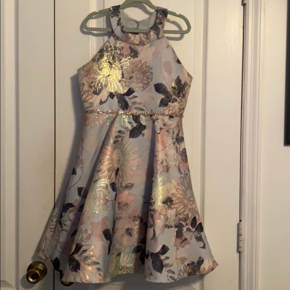 An A-line dress with metallic floral details.